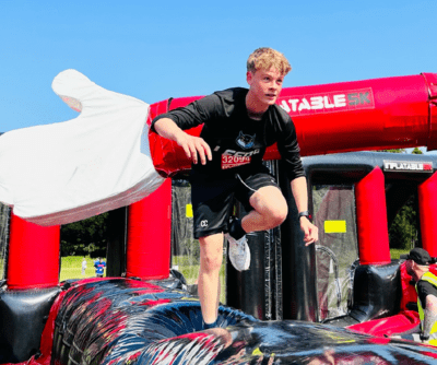Teenager runs across inflatable obstacles