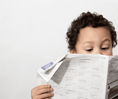 a child reading a newspaper